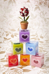 Colorful candle cube with rose bouquet