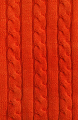 Detail roter Pullover, Zopfmuster