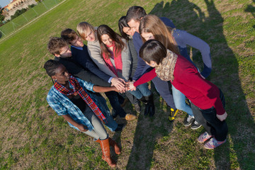 Happy College Students with Hands on Stack.