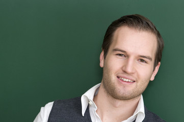 Happy smile from Teacher at the blackboard.