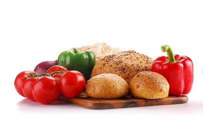 Composition with bread and vegetables on breadboard