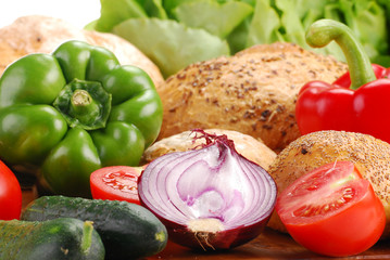 Composition with bread and vegetables on breadboard