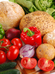 Composition with bread and vegetables on breadboard