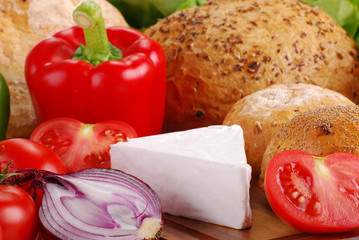 Composition with bread and vegetables on breadboard