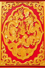 Fototapeta na wymiar golden dragon decorated on red wood in chinese temple,Nonthaburi