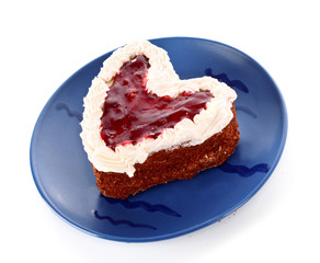 sweet cake in heart shape on blue plate
