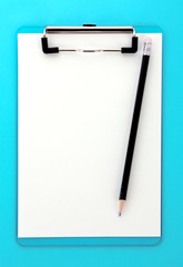 Clipboard and pencil on blue background