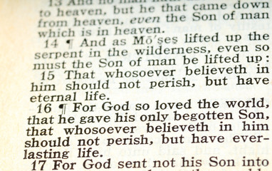 An old King James Version Bible open to John 3:16