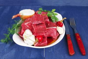 beef meat slices over white bowls ready with red peppers