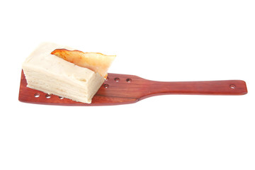 cream cake on wooden spatula