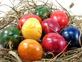 Fototapeta na wymiar A selection of shiny easter eggs on a grass background