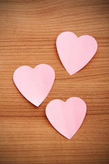 Fototapeta premium Heart shaped sticky notes on the background