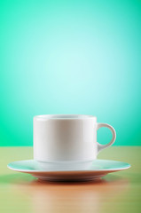 White cup against colourful gradient on the table