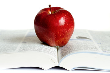 A red apple on a book