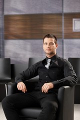 Young businessman sitting in meeting room