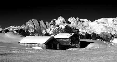 Black and White Landscape, beautiful small houses on side of ski slope in the Dolomites