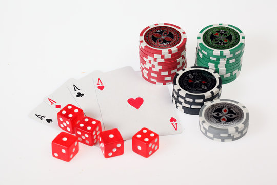 Poker chips, dices and playing cards isolated on white