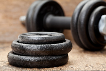 Dumbbell on a wood background
