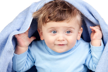 Beautiful blond baby with a towel