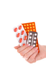red capsules of vitamins in the hand on a white background