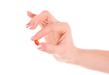 capsule of vitamin E in the hand on a white background