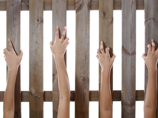 hands holding fence