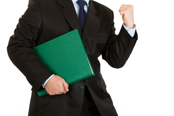 Pleased modern businessman holding folder. Close-up.
