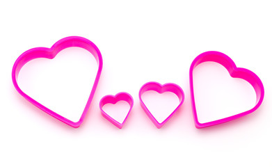 family of pink plastic in heart shape isolated in white