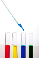 Labolatory glassware with colorful fluids isolated on white