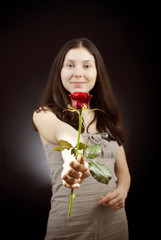 beautiful girl gives a red rose