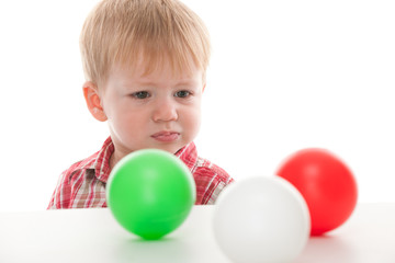 Fototapeta na wymiar Confused kid looking at balls