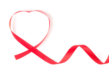 Red ribbon curled in heart shape isolated on white background