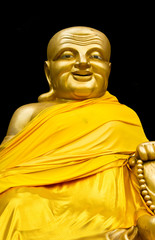 Naklejka premium Golden buddha on black background