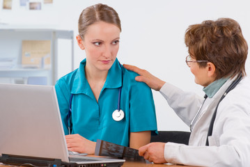A doctor teaches a student