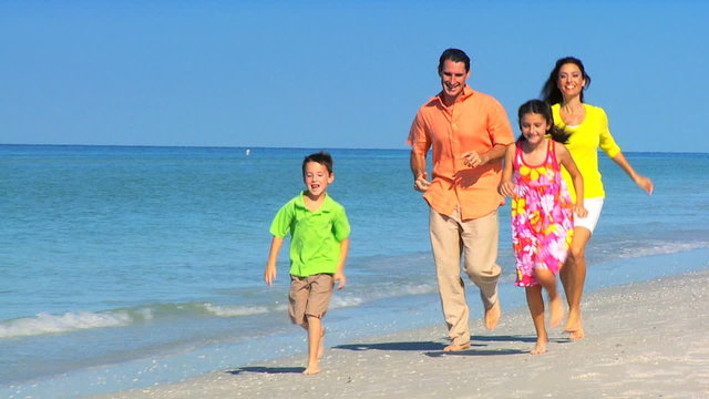Happy Young Family Running on the Beach filmed at 60FPS