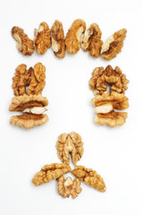 Face made of walnut kernels isolated on white