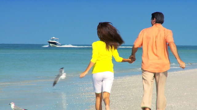 Young Couple Fun Jogging on the Beach filmed at 60FPS