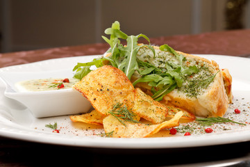 fish pie with sauce and potato chips