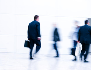 Blurred people walking by