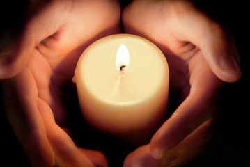 candle between the hands