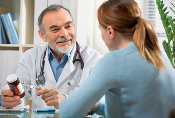 A doctor prescribes a medicine to a young  patient