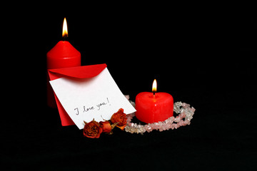 love message and red burning candles