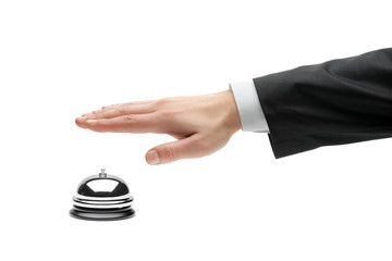 Hand of a businessperson using a hotel bell