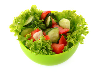 Green salad, cucumber and tomato in green plate isolated on whit