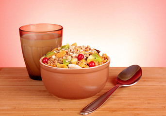 Muesli and milk on red background