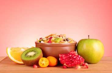 muesli and fruits on red background