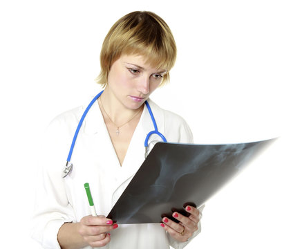 Pensive female doctor looking at an x-ray image