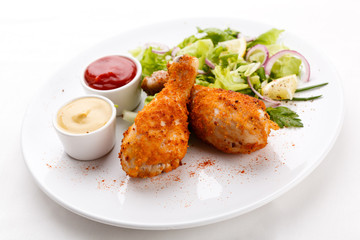 Roasted chicken drumsticks and vegetables