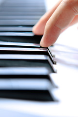 Fototapeta premium Close up of the hands of a young man playing piano