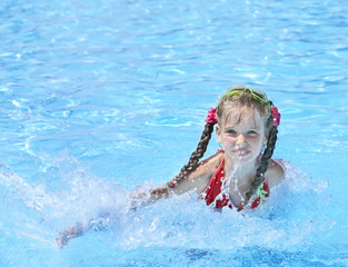 Child swim in swimming pool.